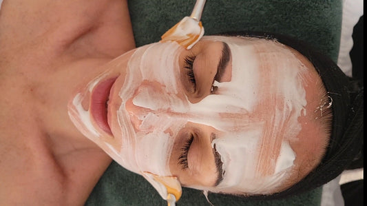 facial mask being brushed on woman